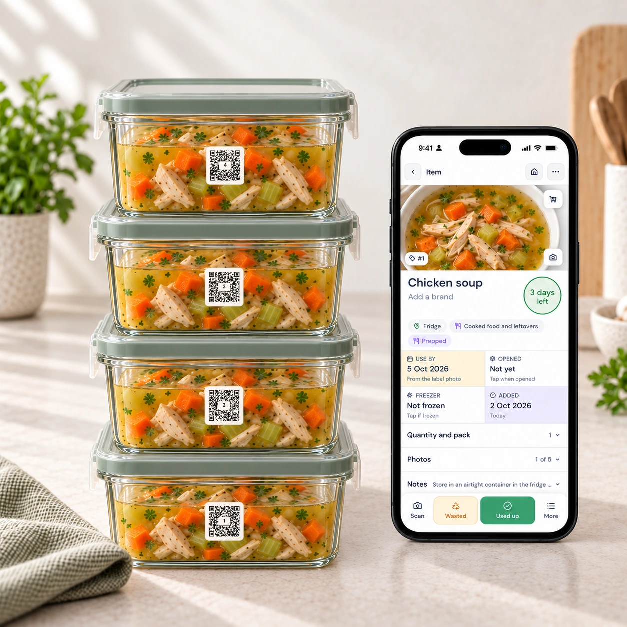 Meal prep containers of chicken soup with QR Pantry labels, and the app open on a phone