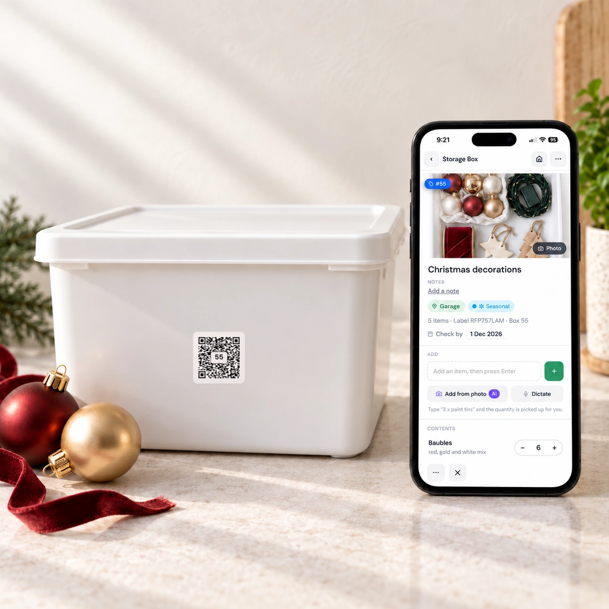 A numbered QR Pantry storage label on a box, with the app showing the Christmas decorations inside.